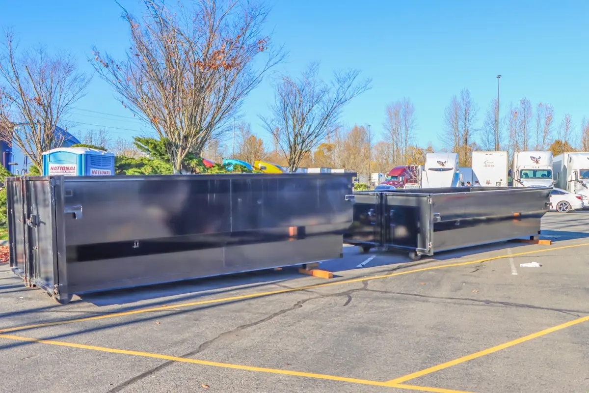 Professional dumpster rental service with roll-off container on residential driveway in South Weber